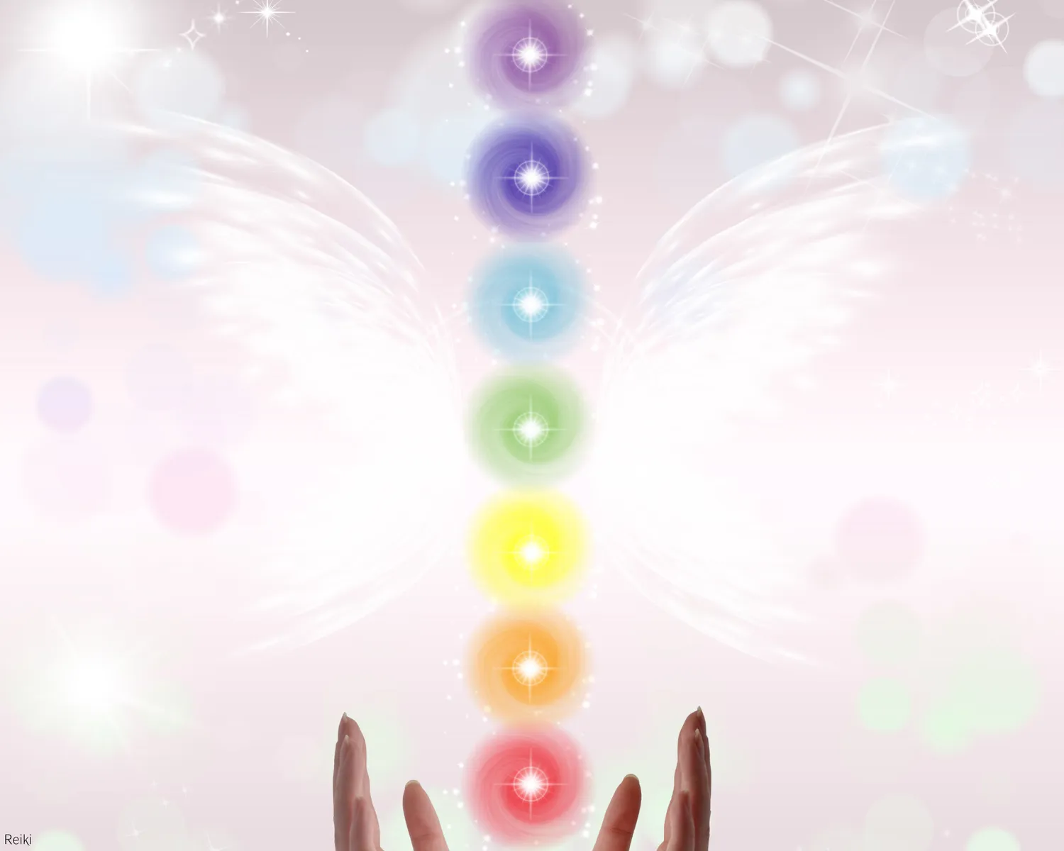 Seven glowing chakra colors stacked above two open hands